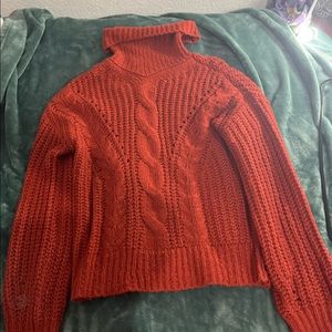 Orange sweater size large but can fit Xl